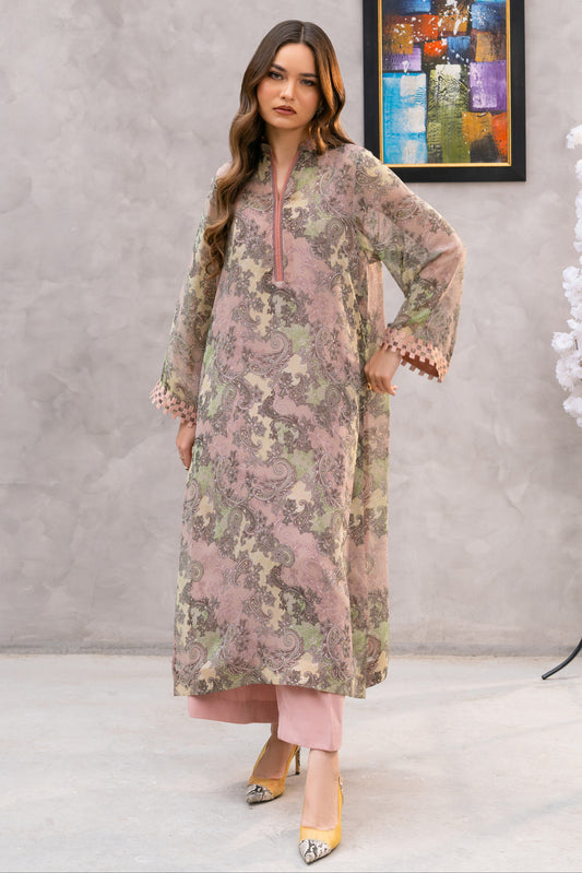 Woman wearing a floral dress in a room with a painting and decorative elements.